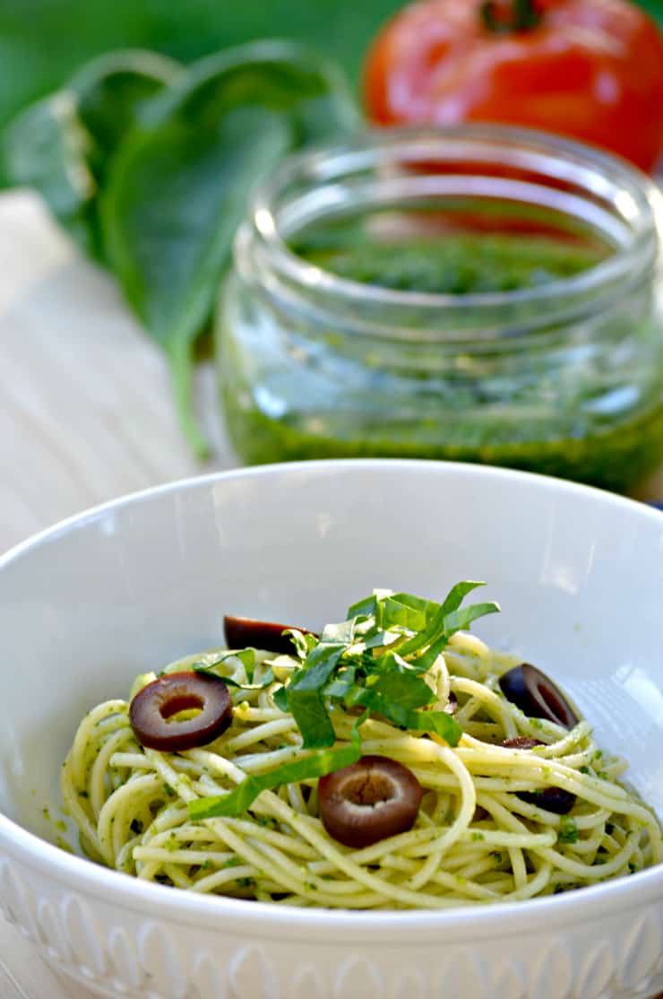 A bowl filled with pasta and vegetables in a cup, with Cashew pesto