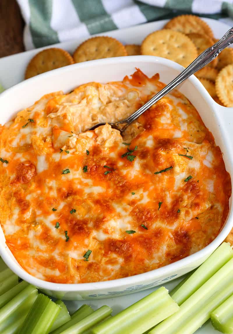 A bowl of food on a plate, with Buffalo chicken dip