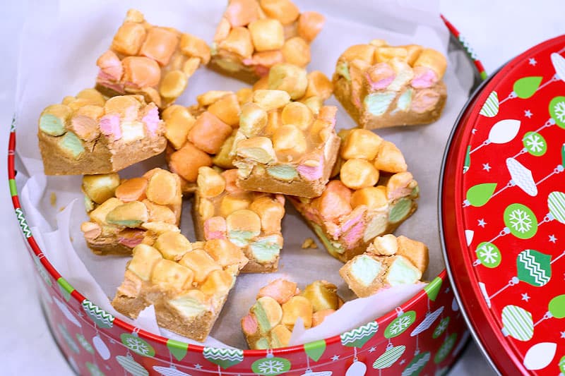 peanut butter confetti squares in a christmas themed tin