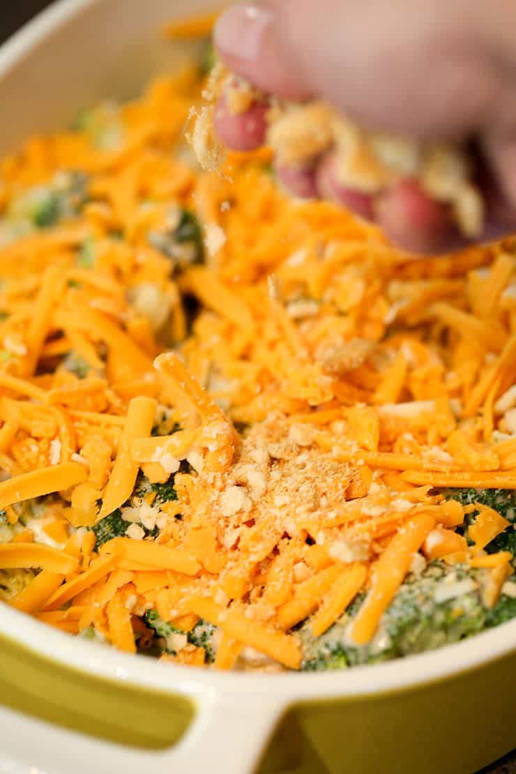 A close up of a bowl of food, with Broccoli and Casserole