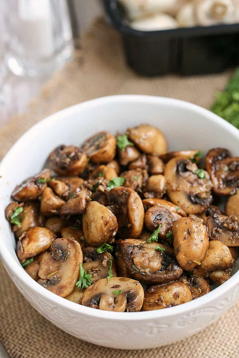 A bowl of food on a plate, with Balsamic mushrooms