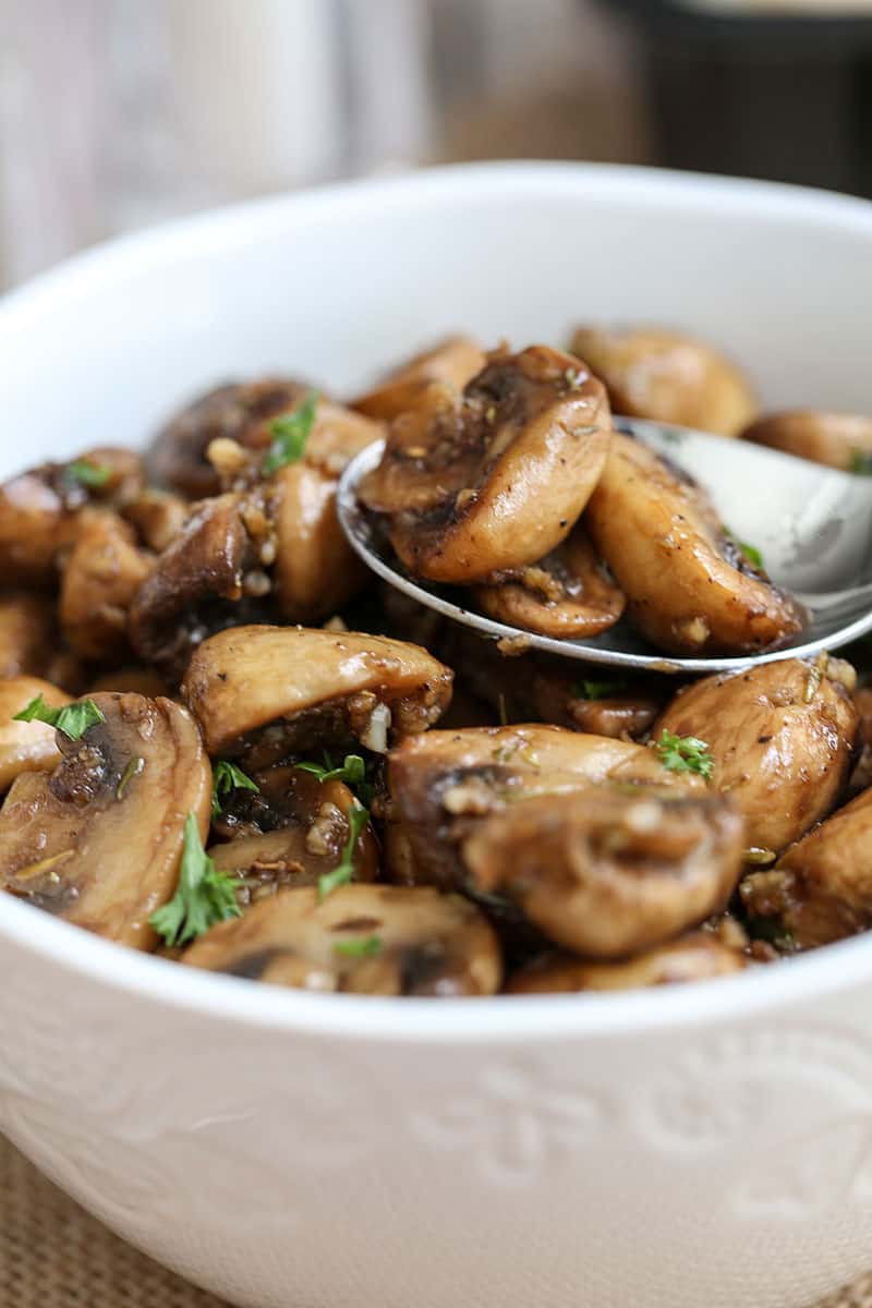 A bowl of food on a plate, with Mushroom and Garlic