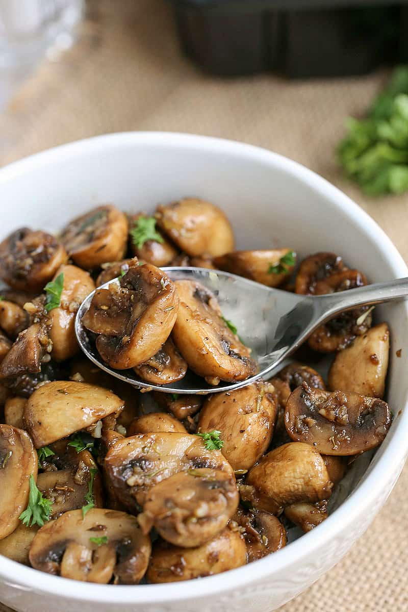 A bowl of food on a plate, with Mushroom and Garlic