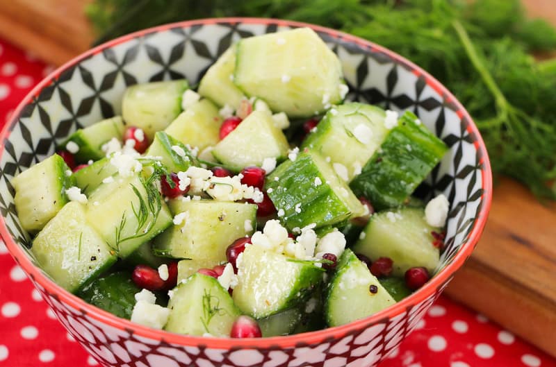 A bowl of fruit salad, with Cucumber and Pomegranate