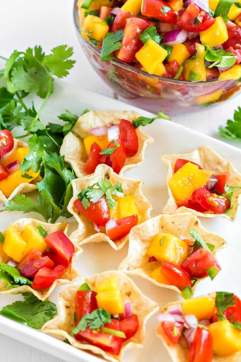 A bowl of fruit salad, with Salsa and Taco