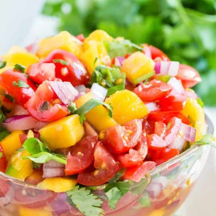 A bowl of fruit salad, with Salsa and Mango