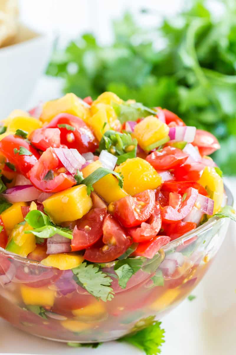 A bowl of fruit salad, with Salsa and Mango