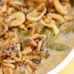 A bowl of food on a plate, with Casserole and Green bean