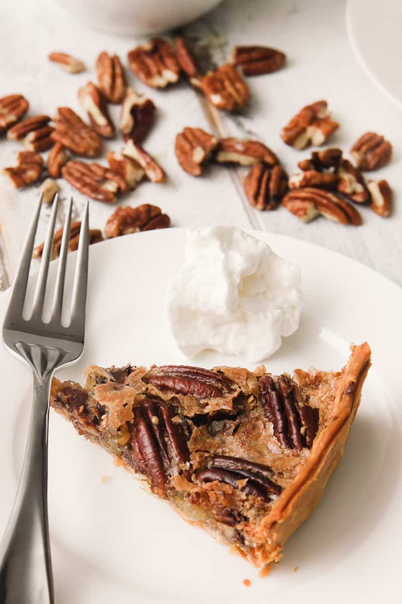 A piece of pie on a plate, with Pecan and Tart