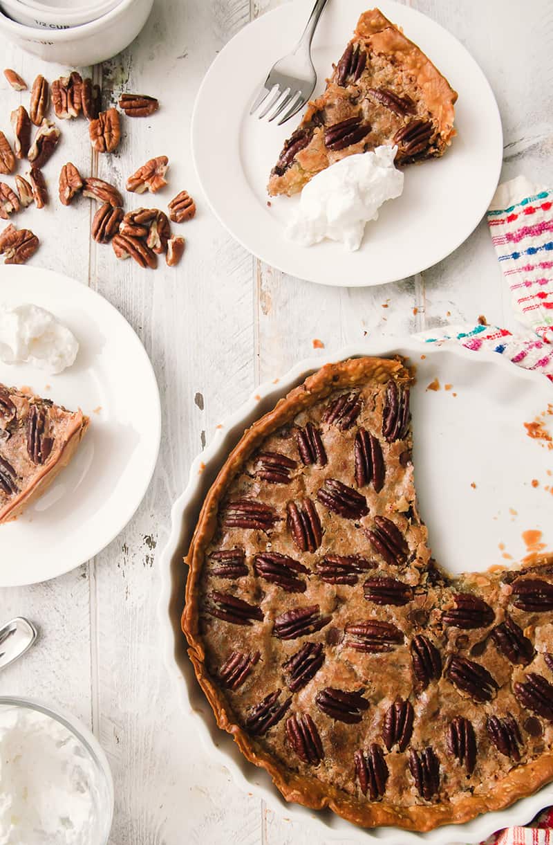 pecan tart on a table with a slice taken out