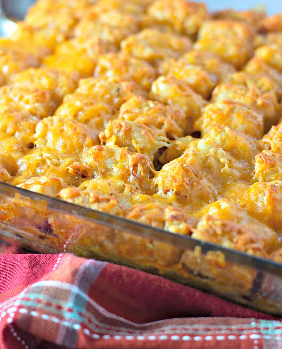 A tray of food, with Casserole and Tater tots