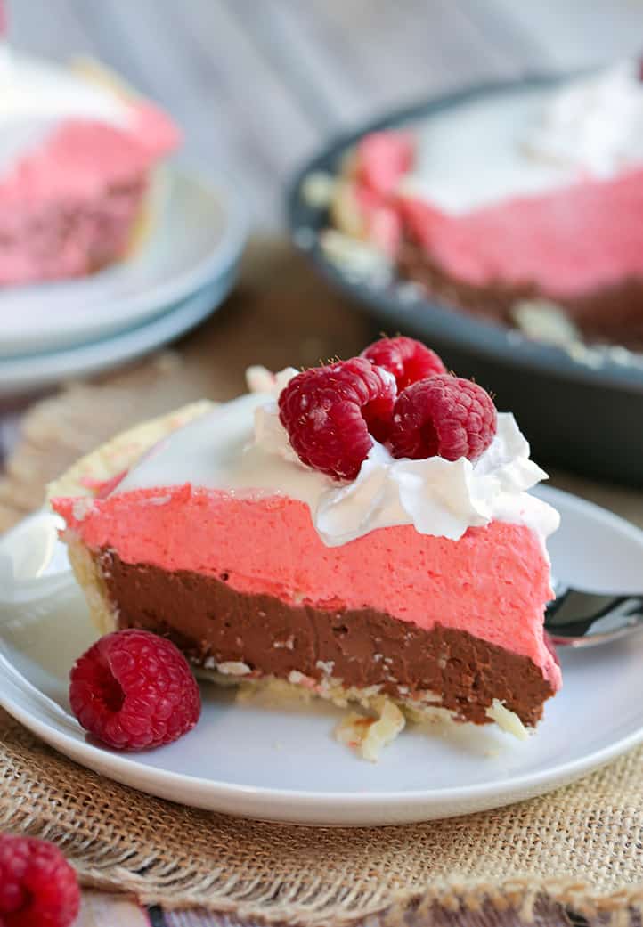 a close up of slice of raspberry cream pie