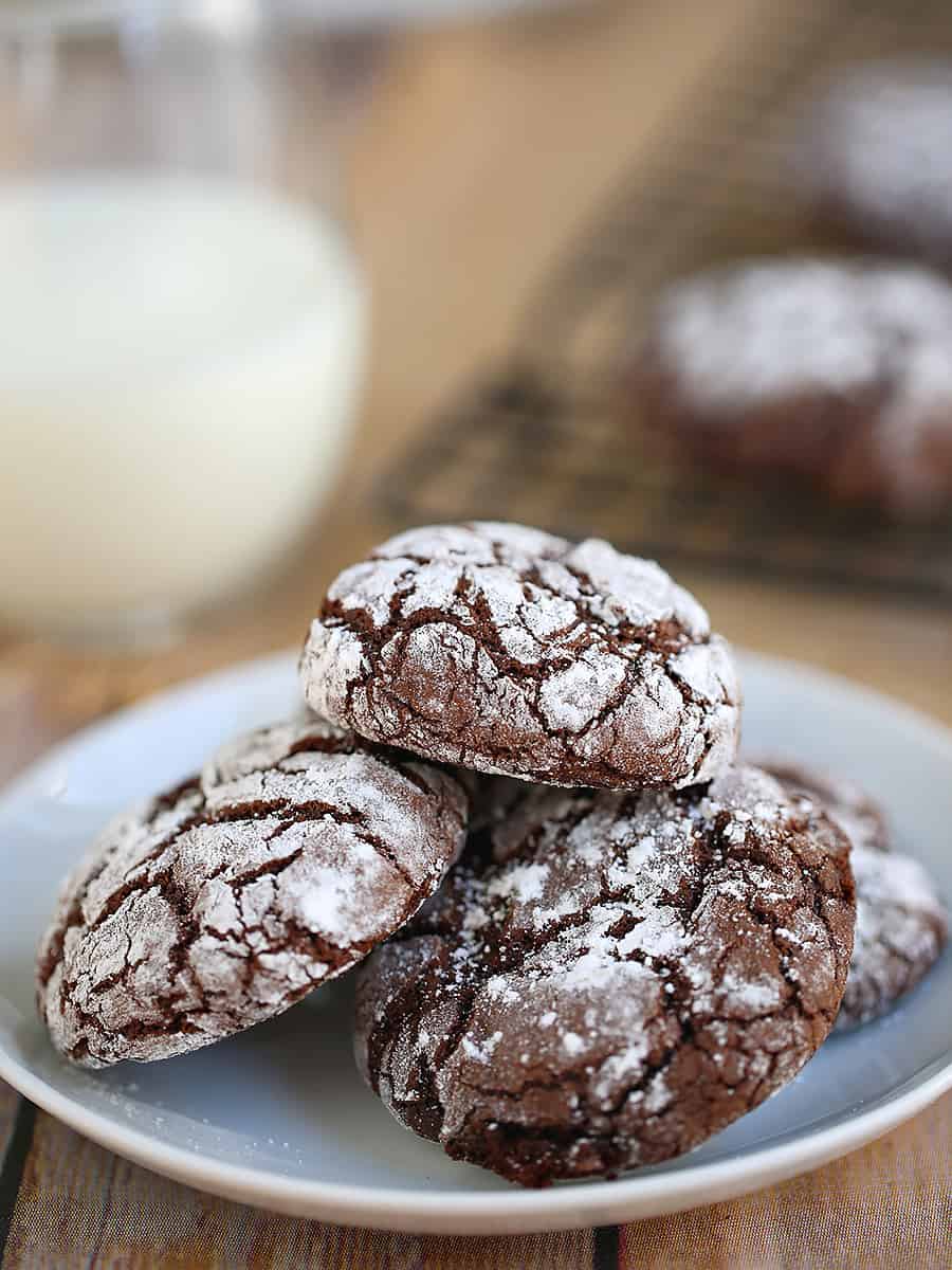 hot chocolate cookies on a white plate with a side of milk