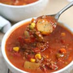 soup on a spoon from a bowl on a table