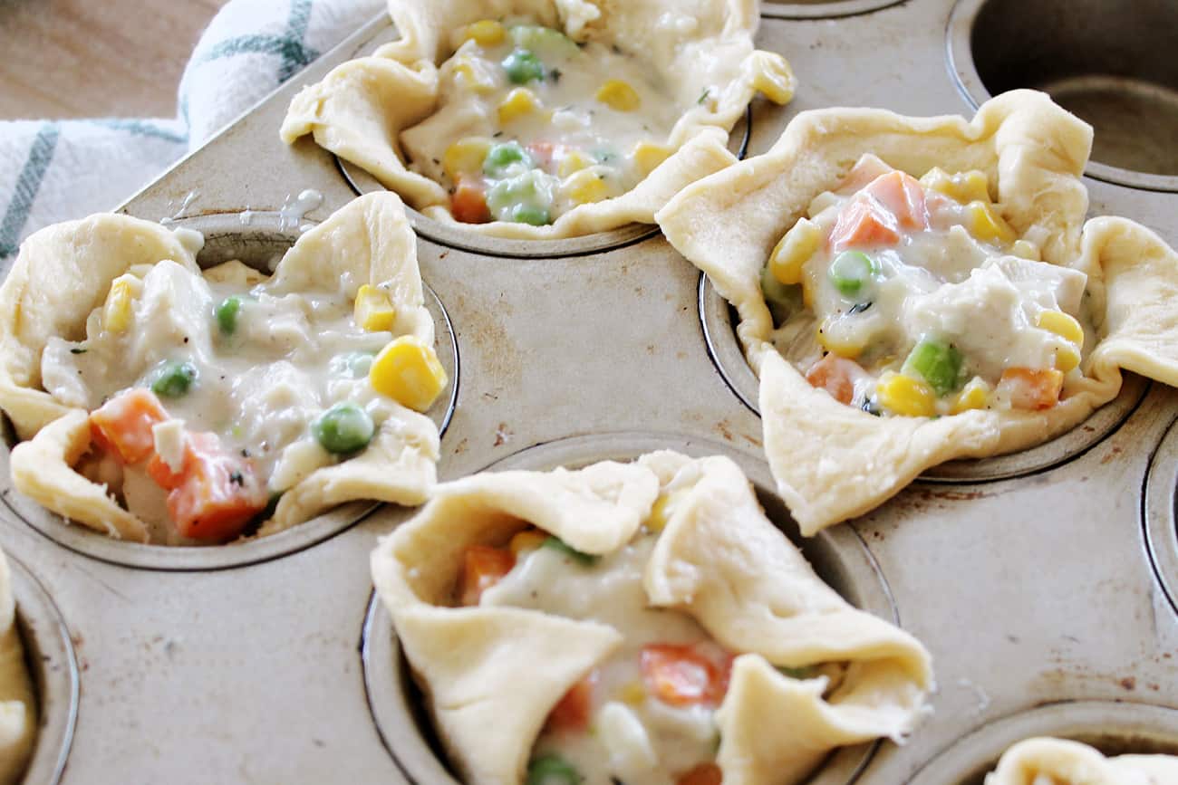 uncooked chicken pot pies in muffin tins