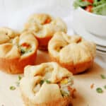 individual mini chicken pot pies on a cutting board