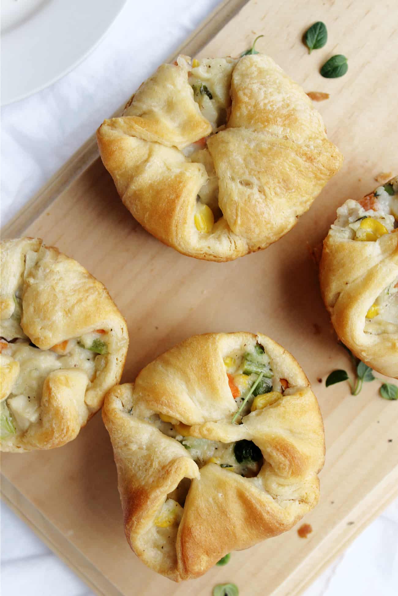 individual chicken pot pies on a cutting board