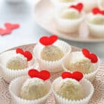 white chocolate and coconut truffles on a plate for valentine's day