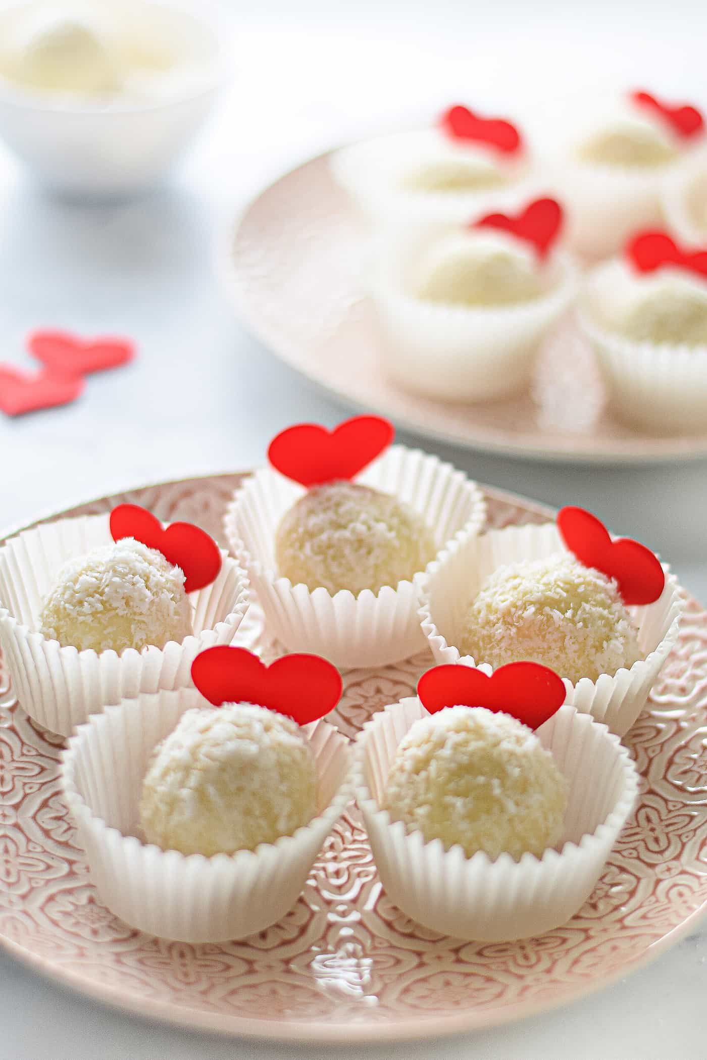 white chocolate and coconut truffles on a plate for valentine's day