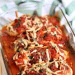 baked bruschetta chicken in a dish with melted mozzarella on top
