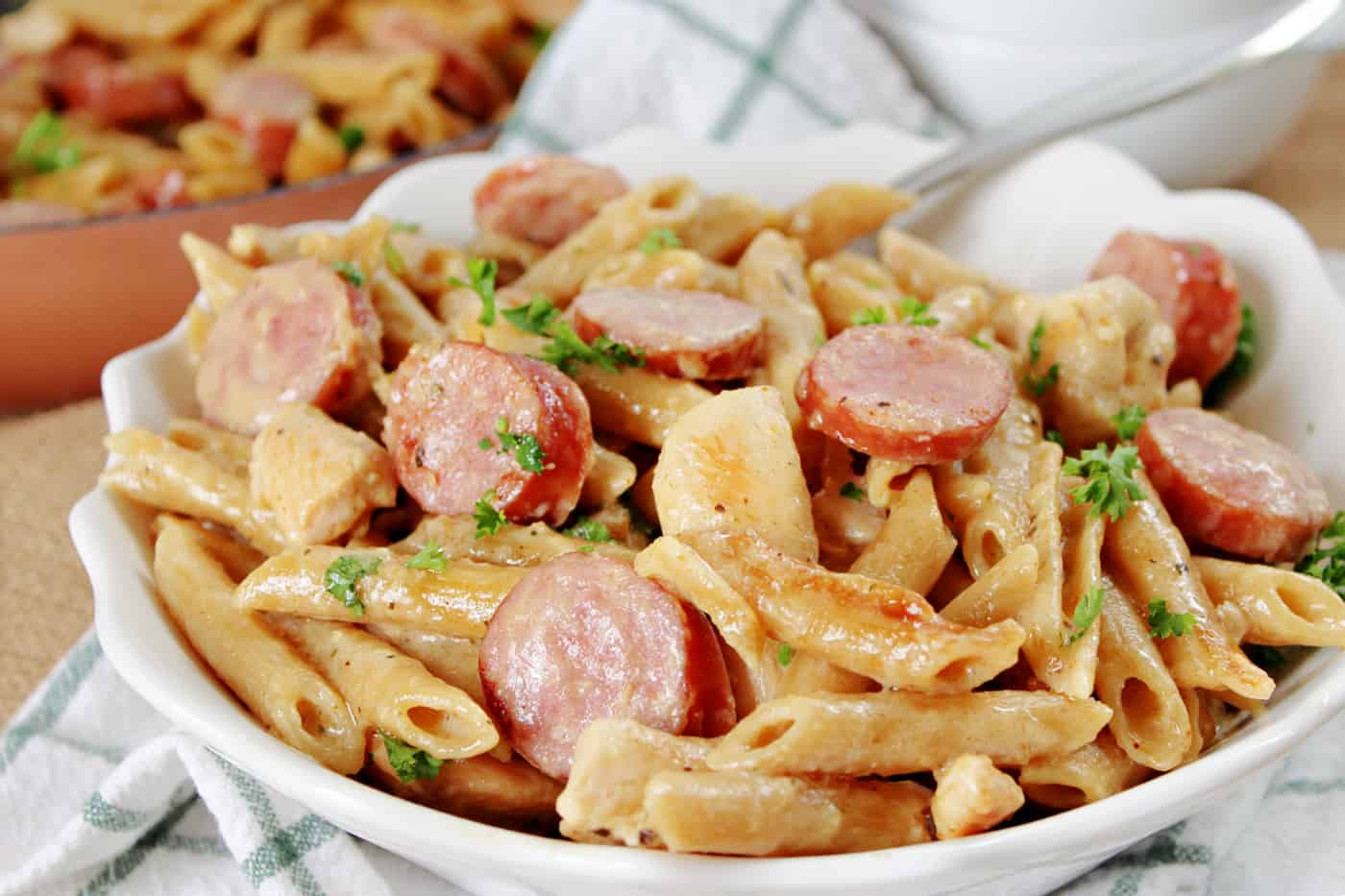 sausage chicken and pasta in a white bowl