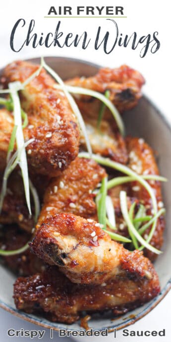 cooked chicken wings in a bowl with green onions and text