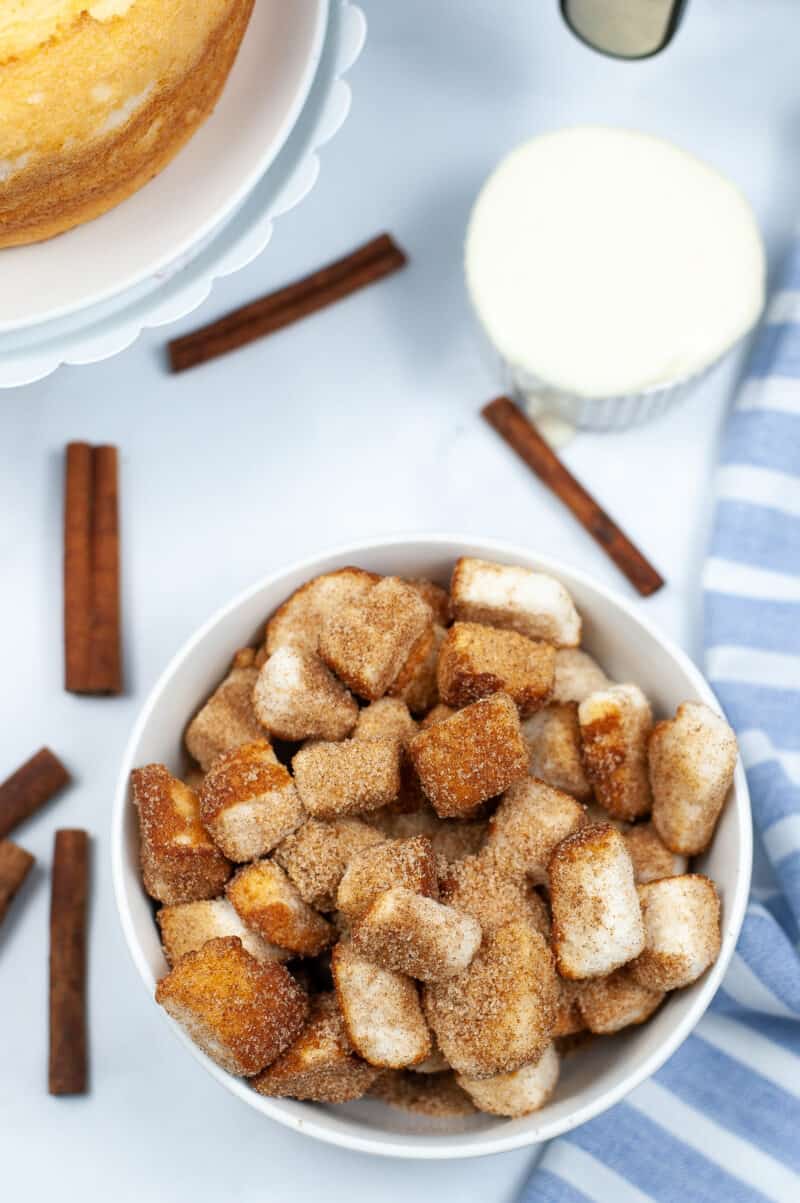 churro pieces in a bowl on the table with cinnamon sticks