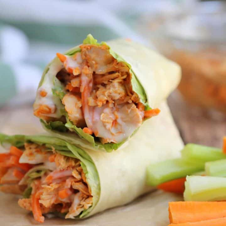 chicken wraps on brown paper with fresh vegetable strips