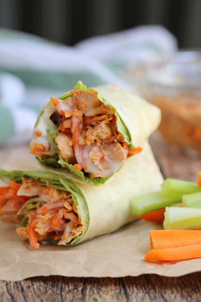 chicken wraps on brown paper with fresh vegetable strips