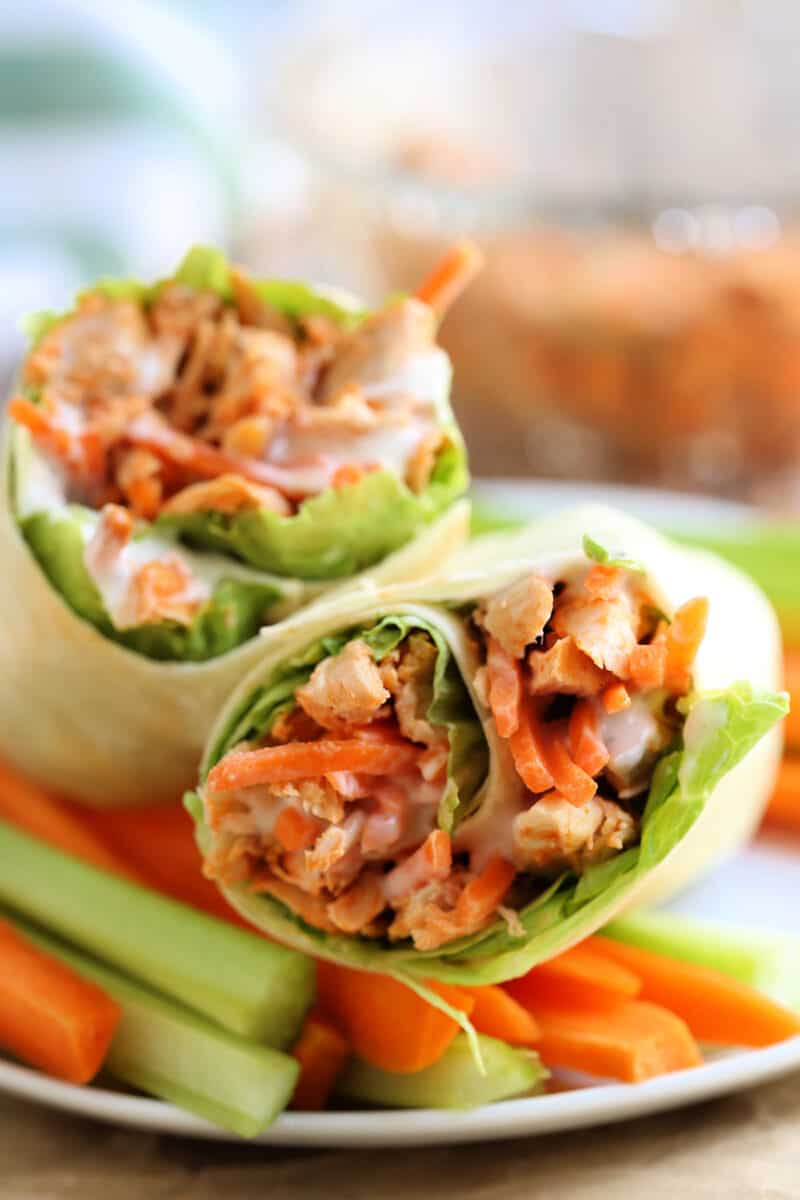 two wraps on a plate with vegetables
