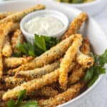 closeup photo of fried green beans in a white bowl with parsley