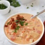 a bowl of chicken soup with a spoon