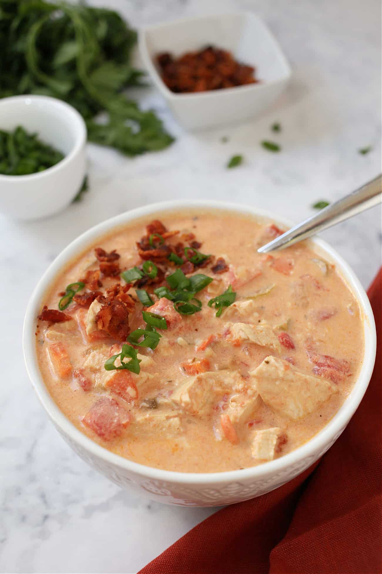 a bowl of chicken soup with a spoon