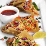 a plate of chicken wonton tacos