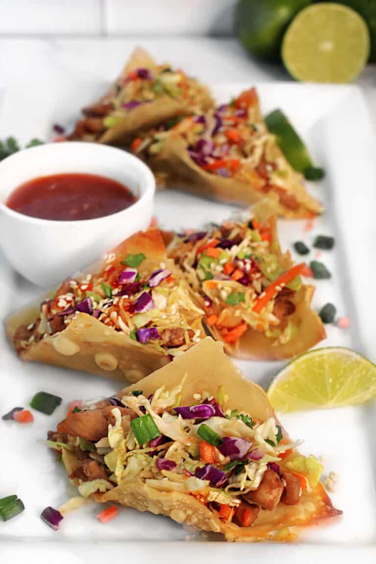 a plate of chicken wonton tacos
