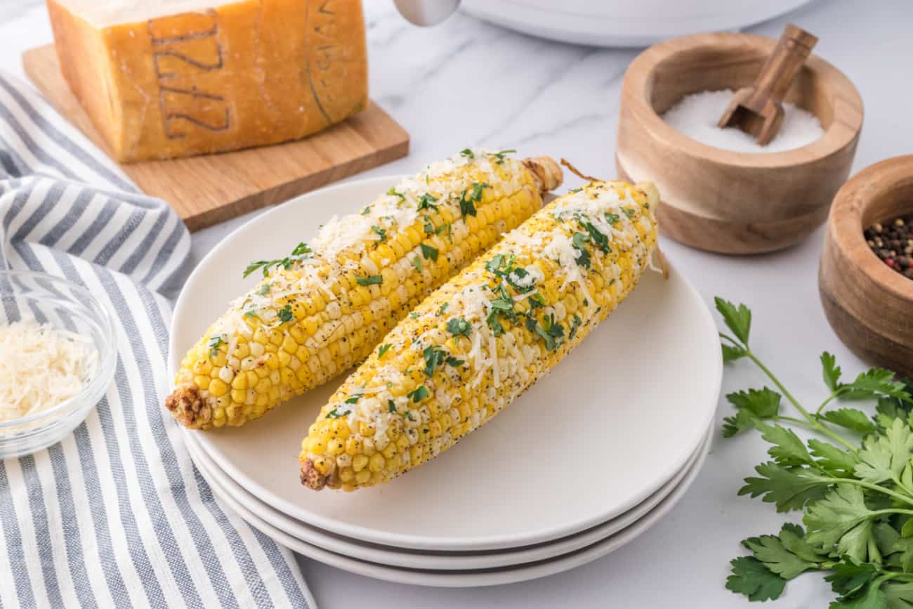 corn on the cob on a white plate