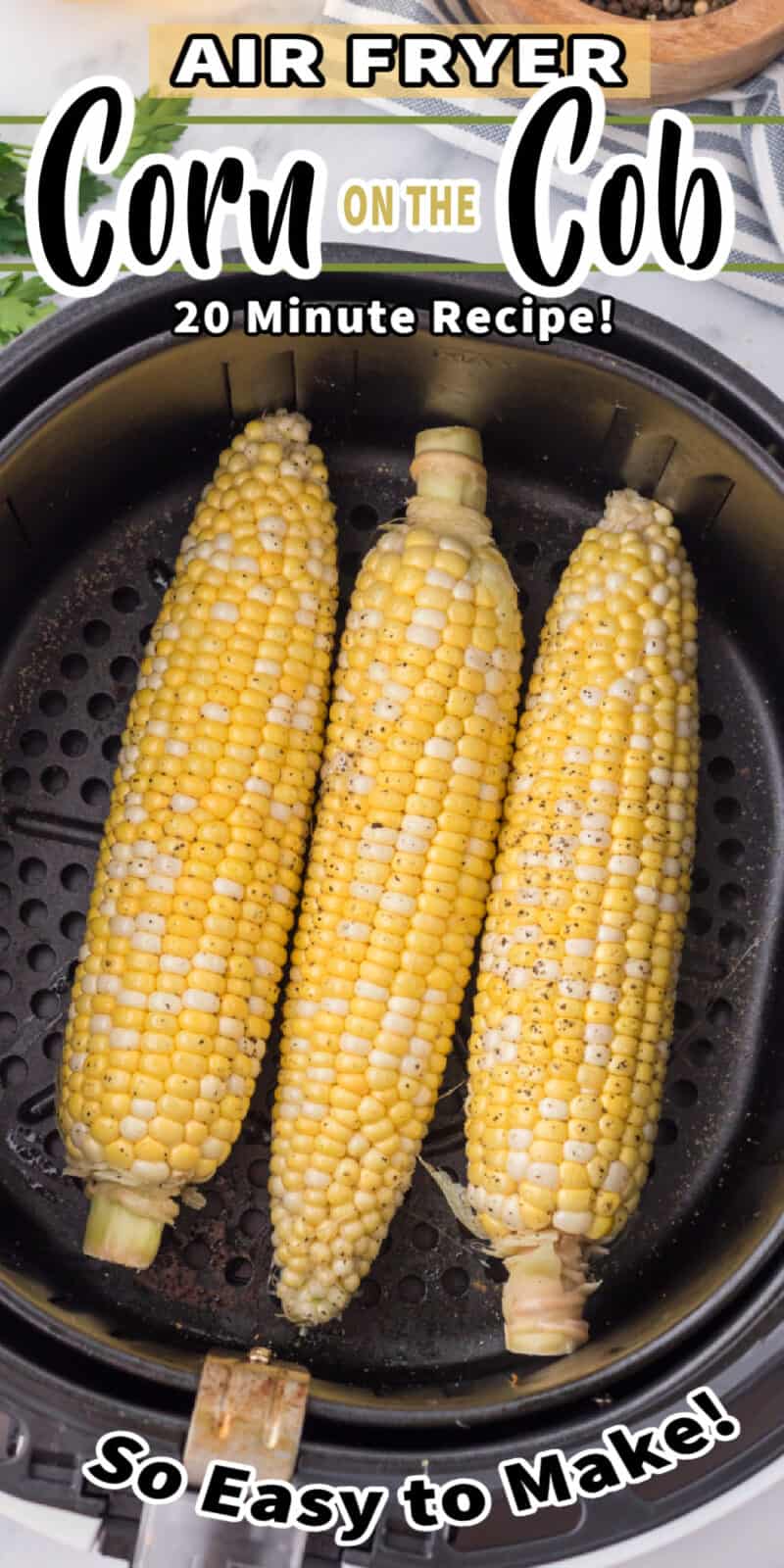 corn on the cob in an air fryer basket with text