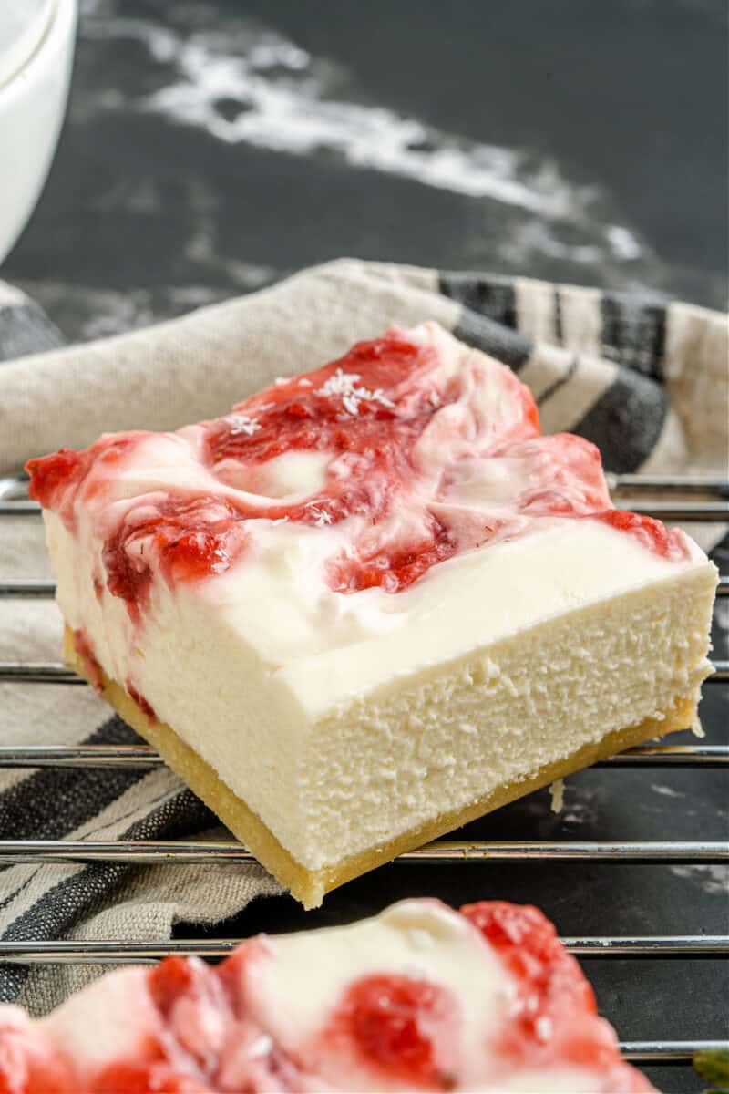A close up of a piece of cheesecake bar