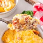 food on a fork, with egg and sausage breakfast