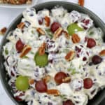food in a bowl with pecans, with grape salad