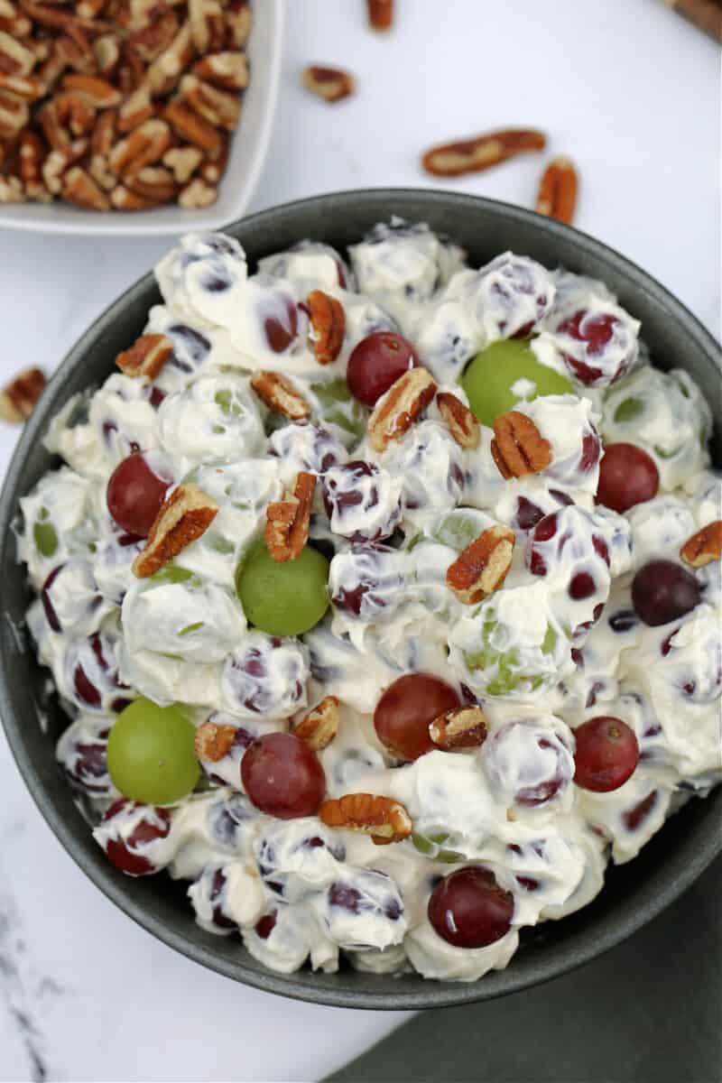 food in a bowl with pecans, with grape salad