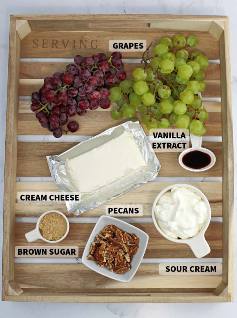 various ingredients on a table with cream cheese and grapes, for grape salad