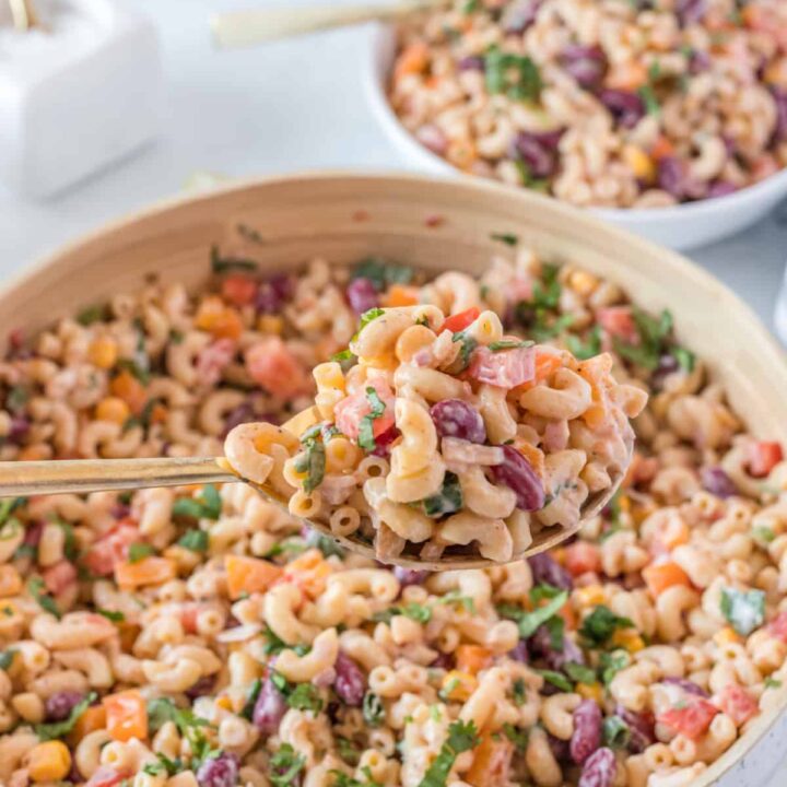 a big bowl of food with a spoon, with mexican macaroni salad