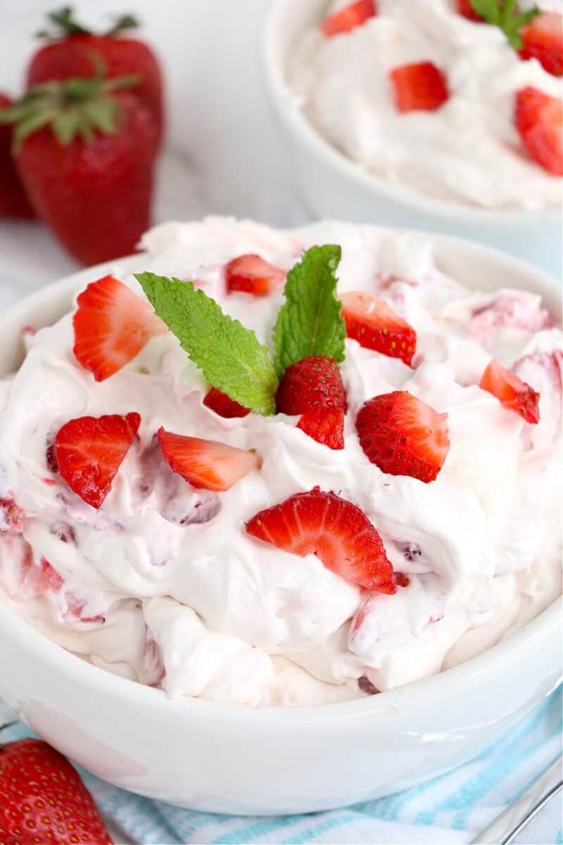 food in a bowl on a table, with Strawberry Fluff Salad recipe