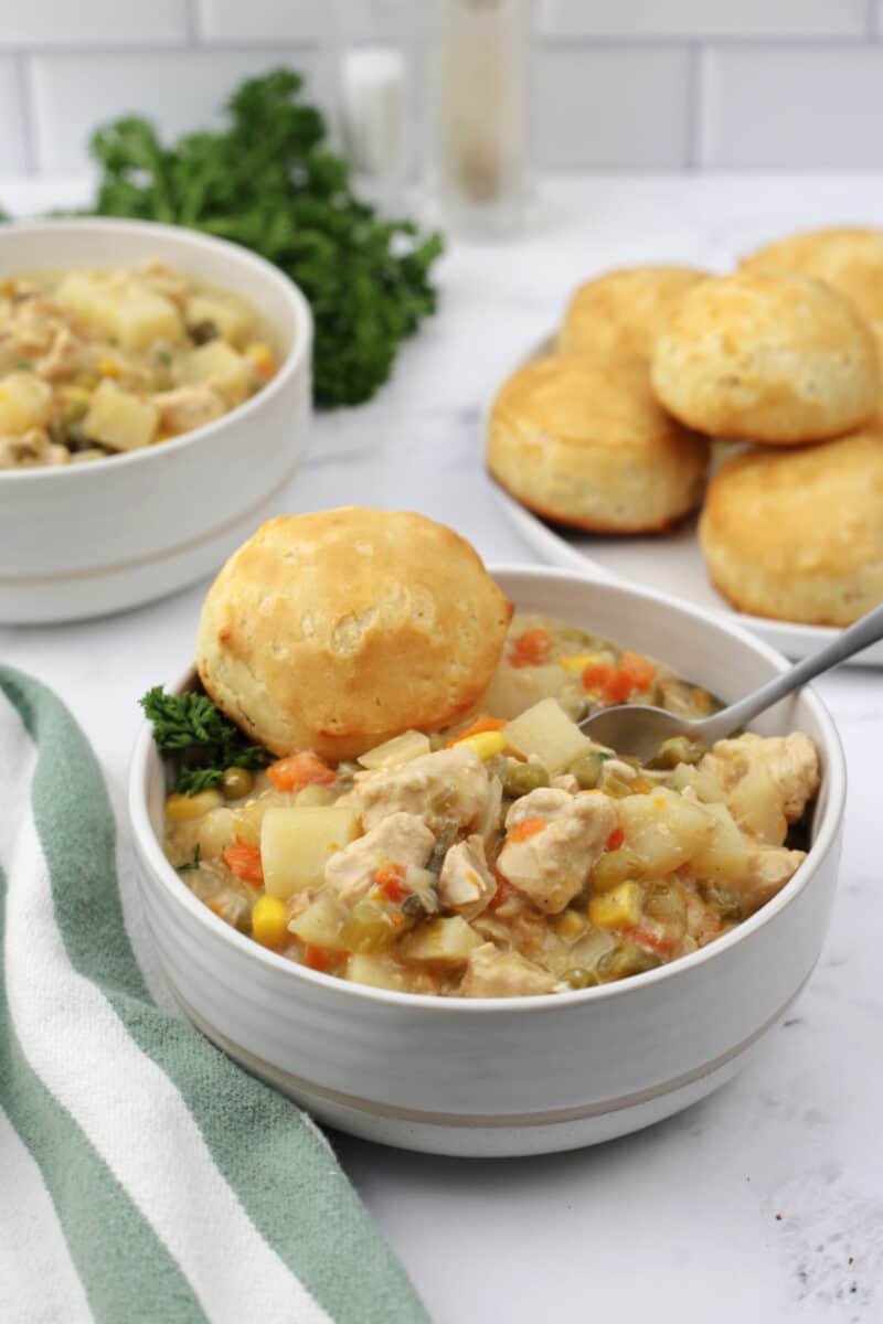 food in a bowl with biscuits, with Crockpot Chicken Pot Pie