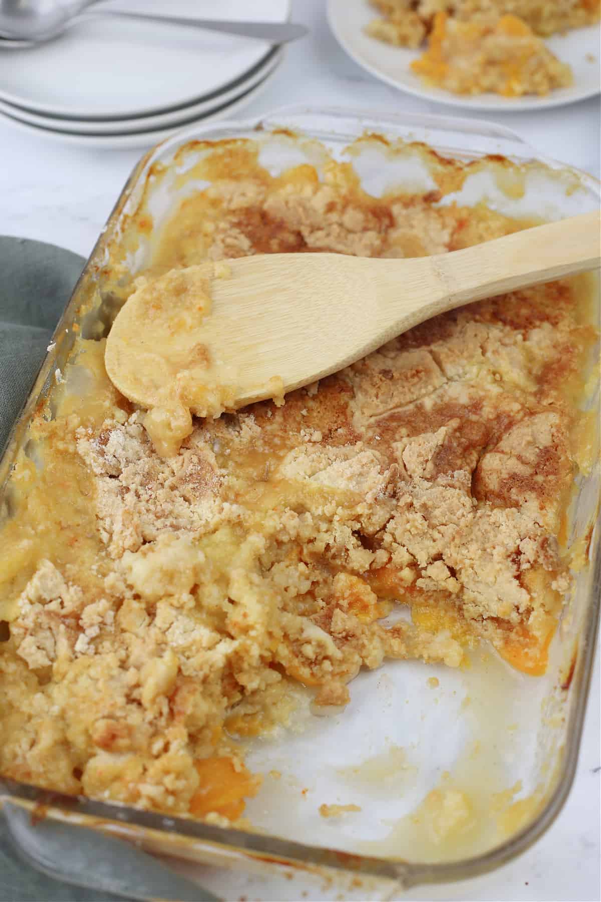 A casserole dish with peach dump cake in it.
