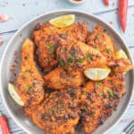 peri peri chicken pieces on a plate.