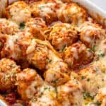 melted cheese covered chicken parmesan meatballs in a baking dish.