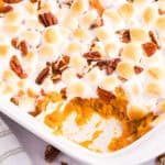 Indulge in the perfect holiday side dish with our irresistible Sweet Potato Casserole recipe, complete with a golden brown marshmallow and pecan topping. This comforting side dish that is both savory and sweet is a classic favorite for the holiday season and any family gathering. 