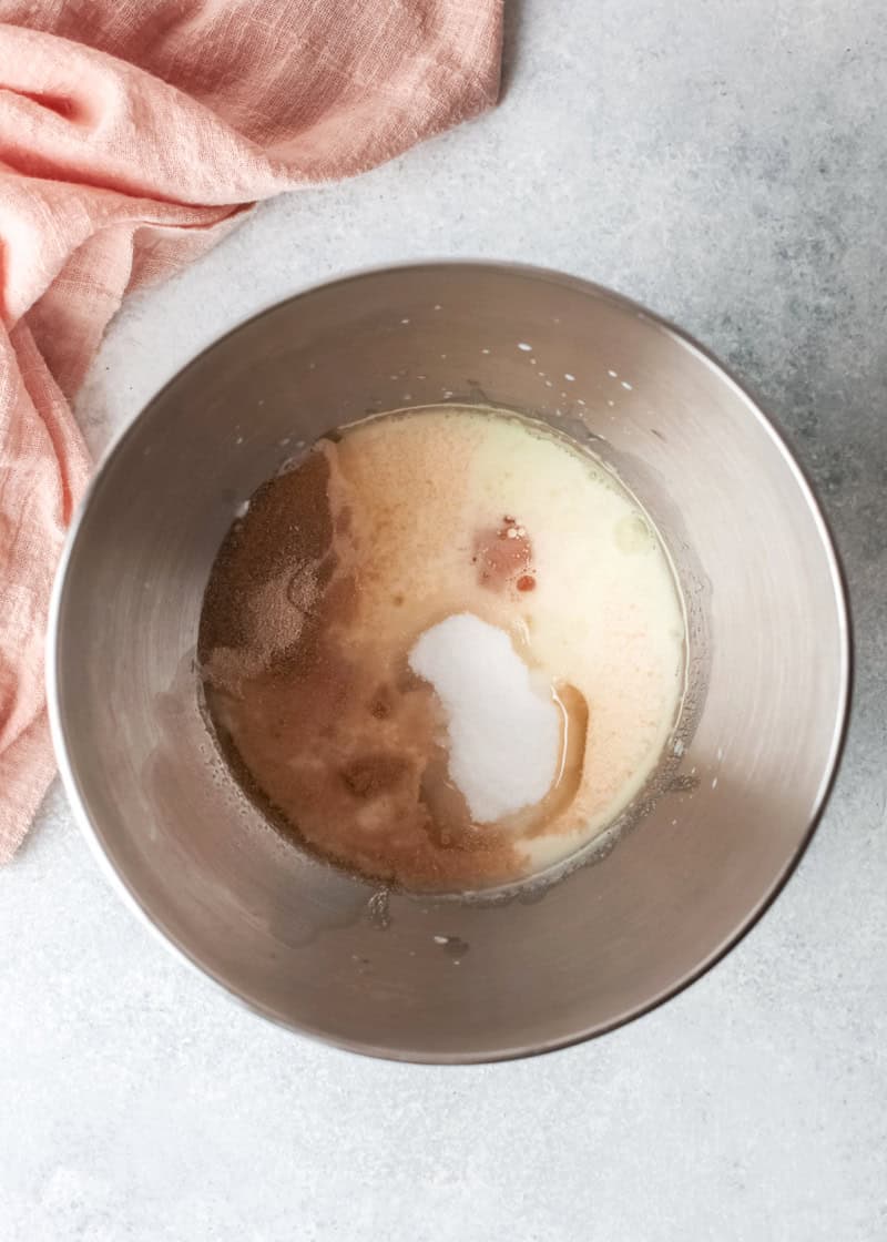 a mixture in a silver steel mixing bowl on a table.